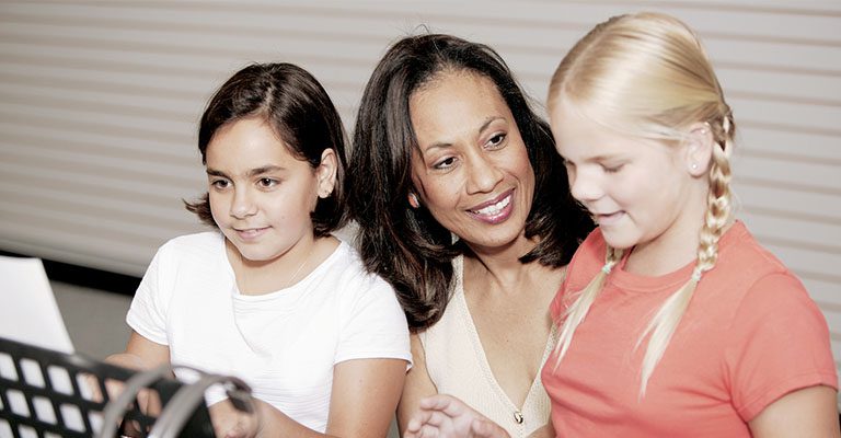 Music teacher with two young female students