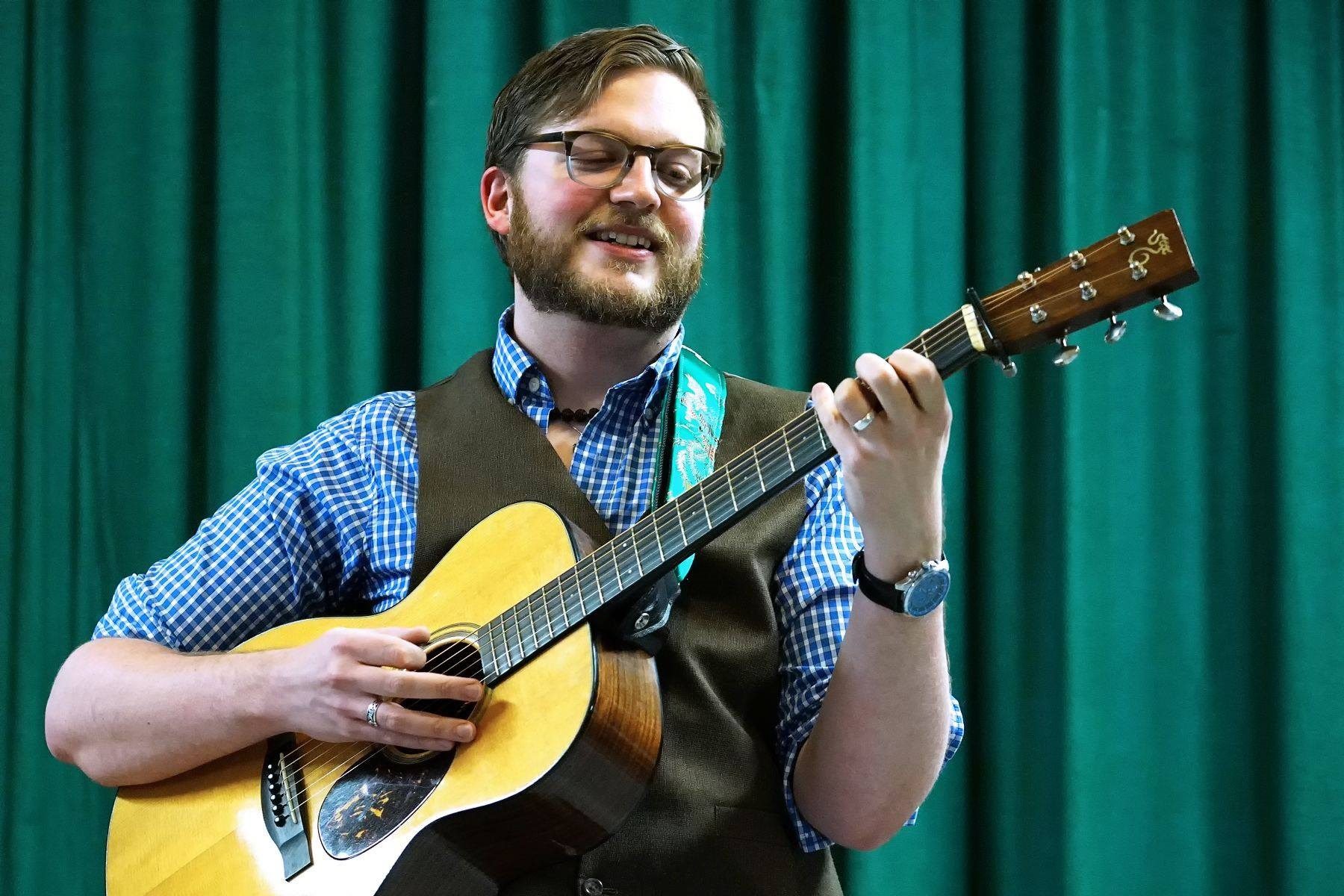 Davey Harrison playing guitar, headshot