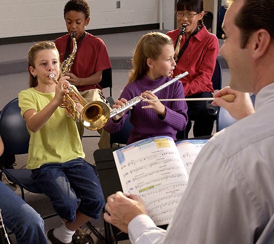 Students in band working with director