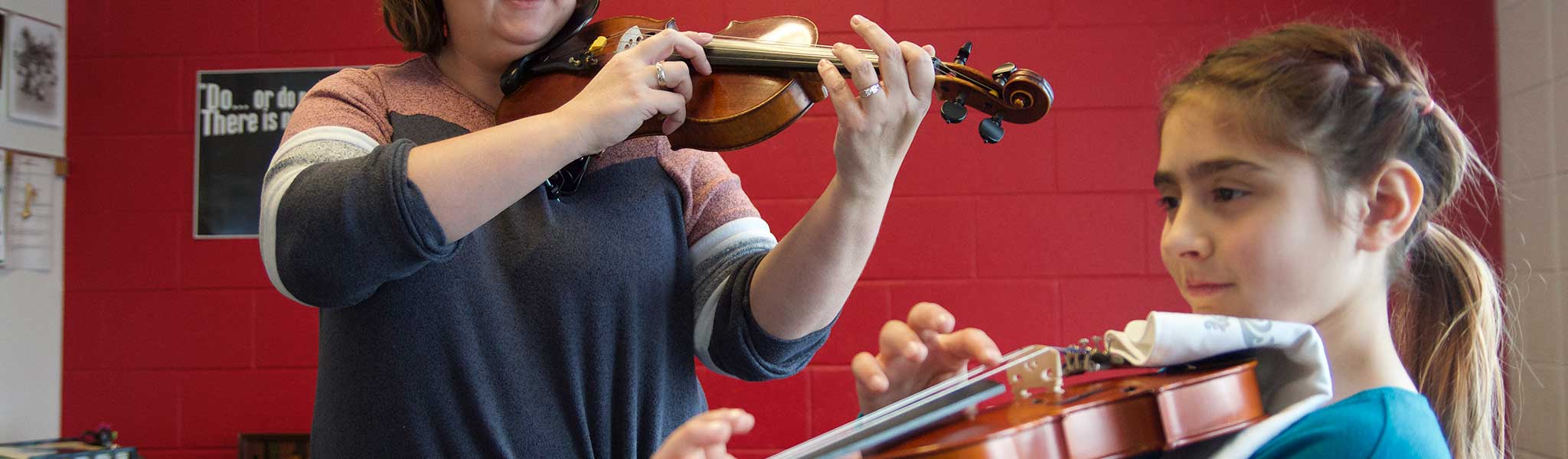 Young student learning to play violin