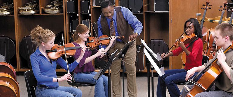 Orchestra director working with students