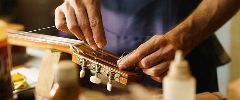 Use your own - Get repairs if needed! Guy restringing a guitar
